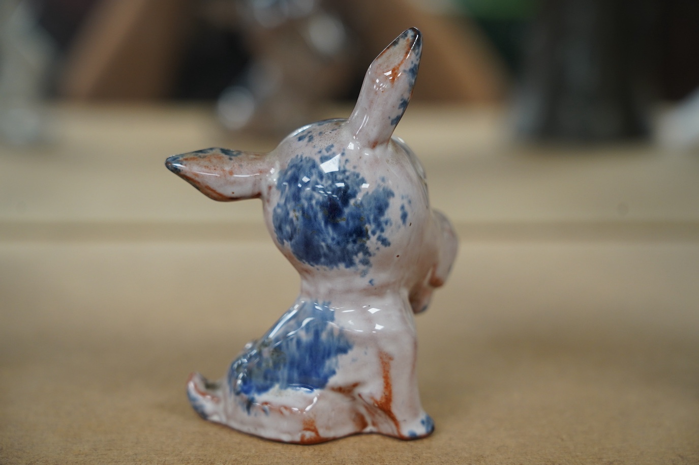 An unusual early Goebel tin glazed terracotta grotesque dog, in the style of Ida Meisinger, impressed no. KT.626., 10.5cm. Condition - good